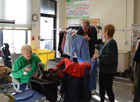 Thrift Volunteers 472x344 Volunteers sorting and tagging Thrift Shop donations