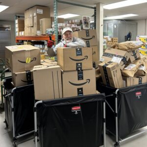 Bins of Amazon-delivered items being handled by Food Pantry staff